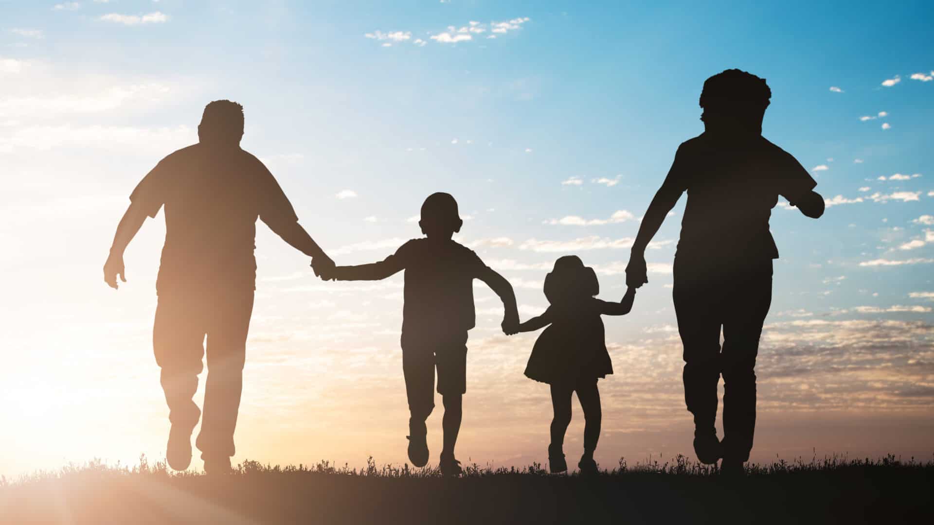silhouette of family running in park