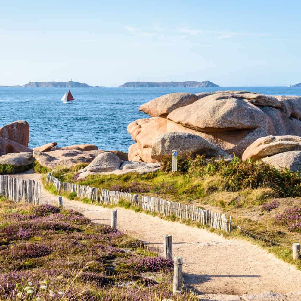 coastal path in the granite blockfield on the pink granite coast in northern brittany, france.