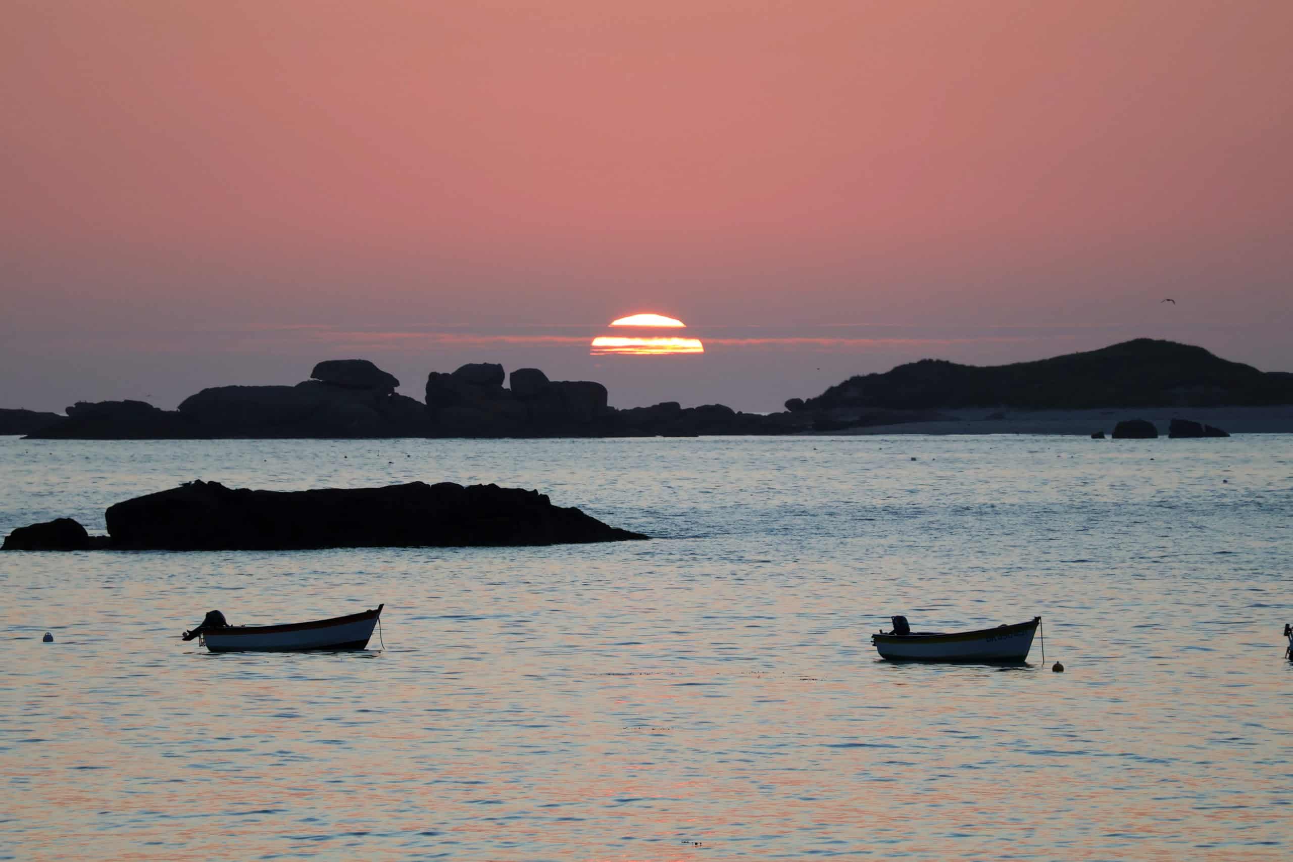 Coucher de soleil sur mer, barques et rochers